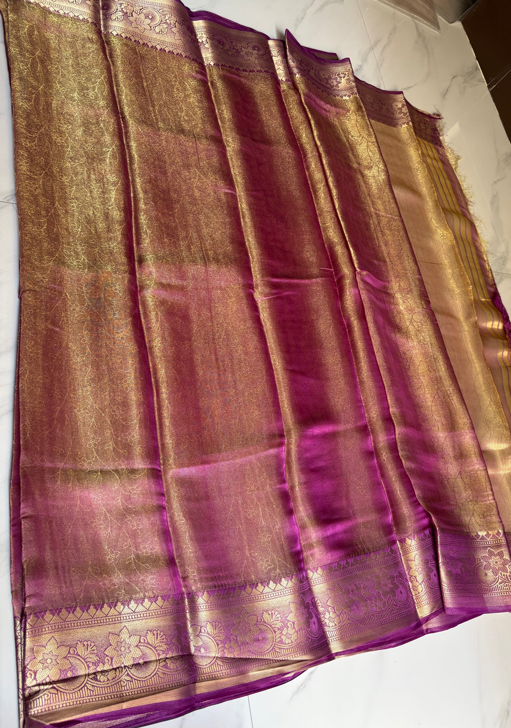 Elegant with this stunning magenta - Gold Tissue saree, beautifully enhanced by a rich zari weave.