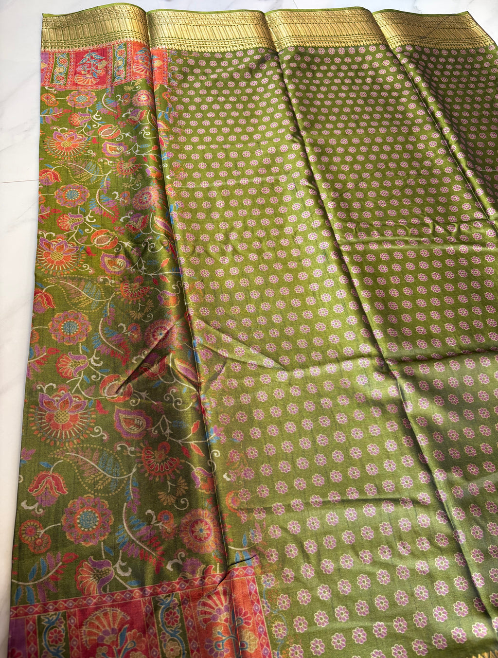 Elegant olive green saree featuring vibrant floral digital prints and an golden zari border