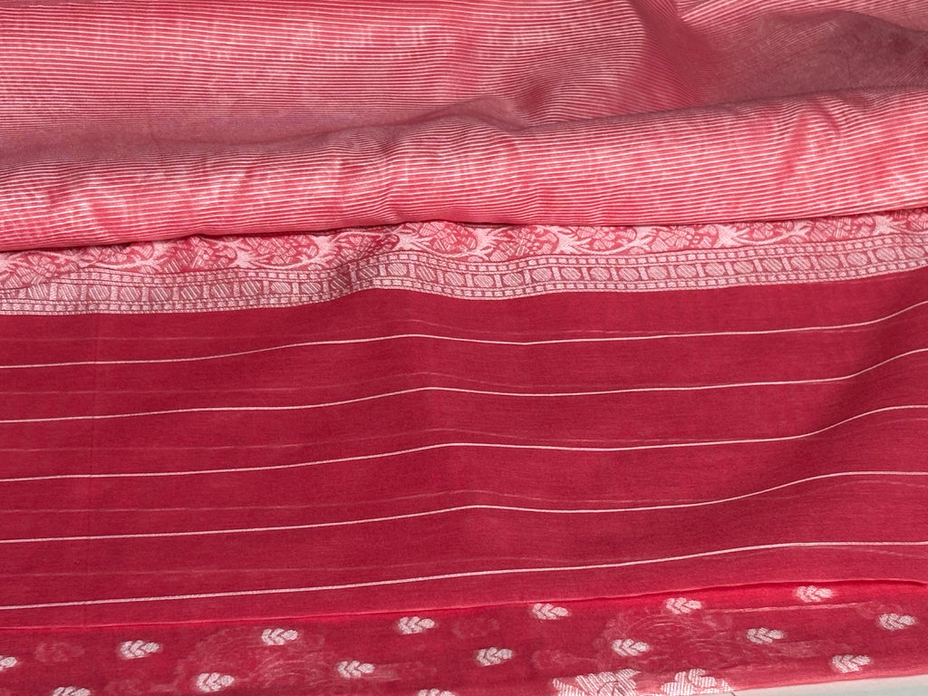 Elegant rani pink saree featuring intricate silver motifs and delicate buttas across the body with silver border