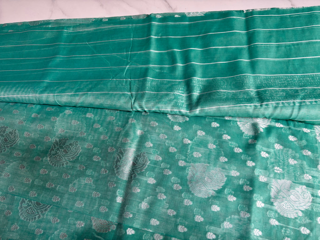Elegant teal green Cotton saree featuring intricate silver paisley motifs and delicate detailing with silver border