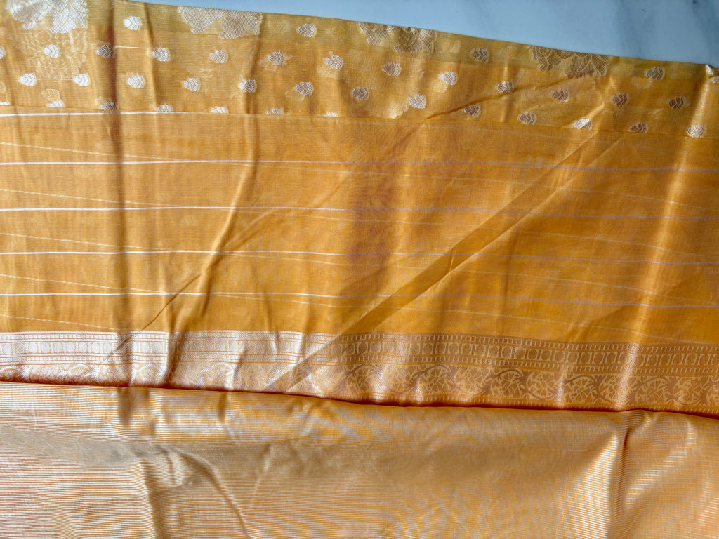 Elegant mustard yellow Cotton saree featuring intricate silver paisley motifs and delicate detailing with silver border