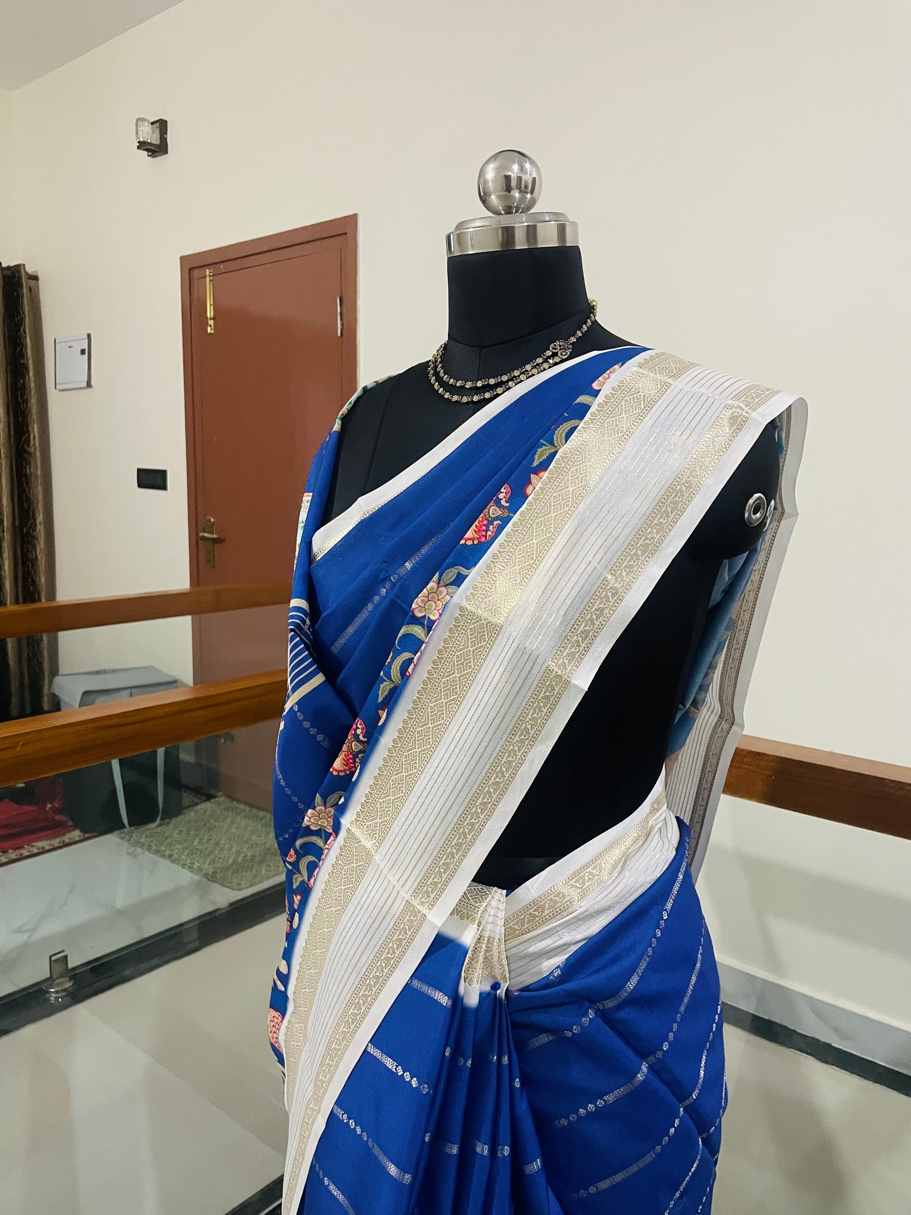 Elegant Royal Blue Yulu Crape semi silk Saree with Elephant artistry Prints with Gold Zari White Border.