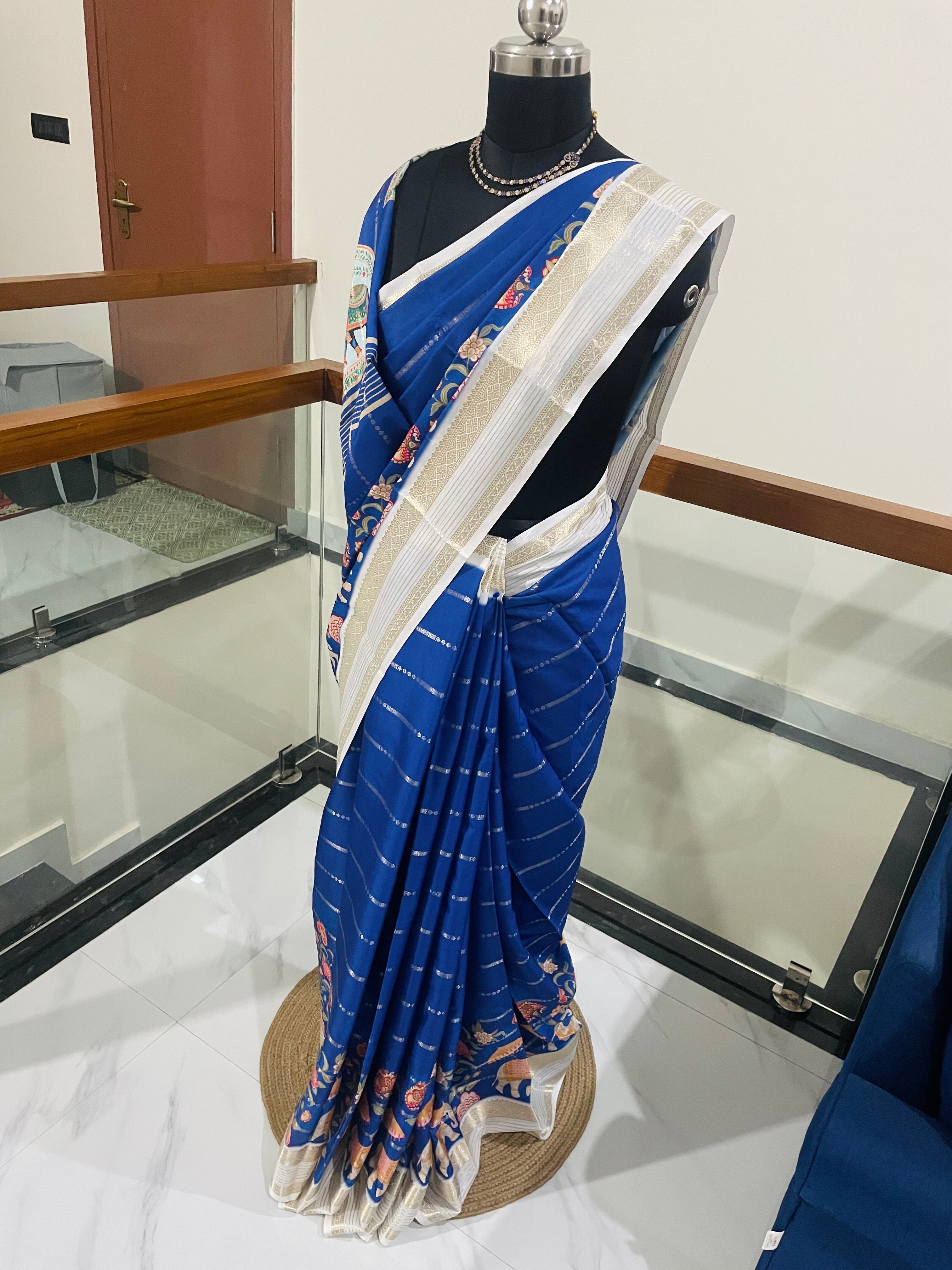 Elegant Royal Blue Yulu Crape semi silk Saree with Elephant artistry Prints with Gold Zari White Border.