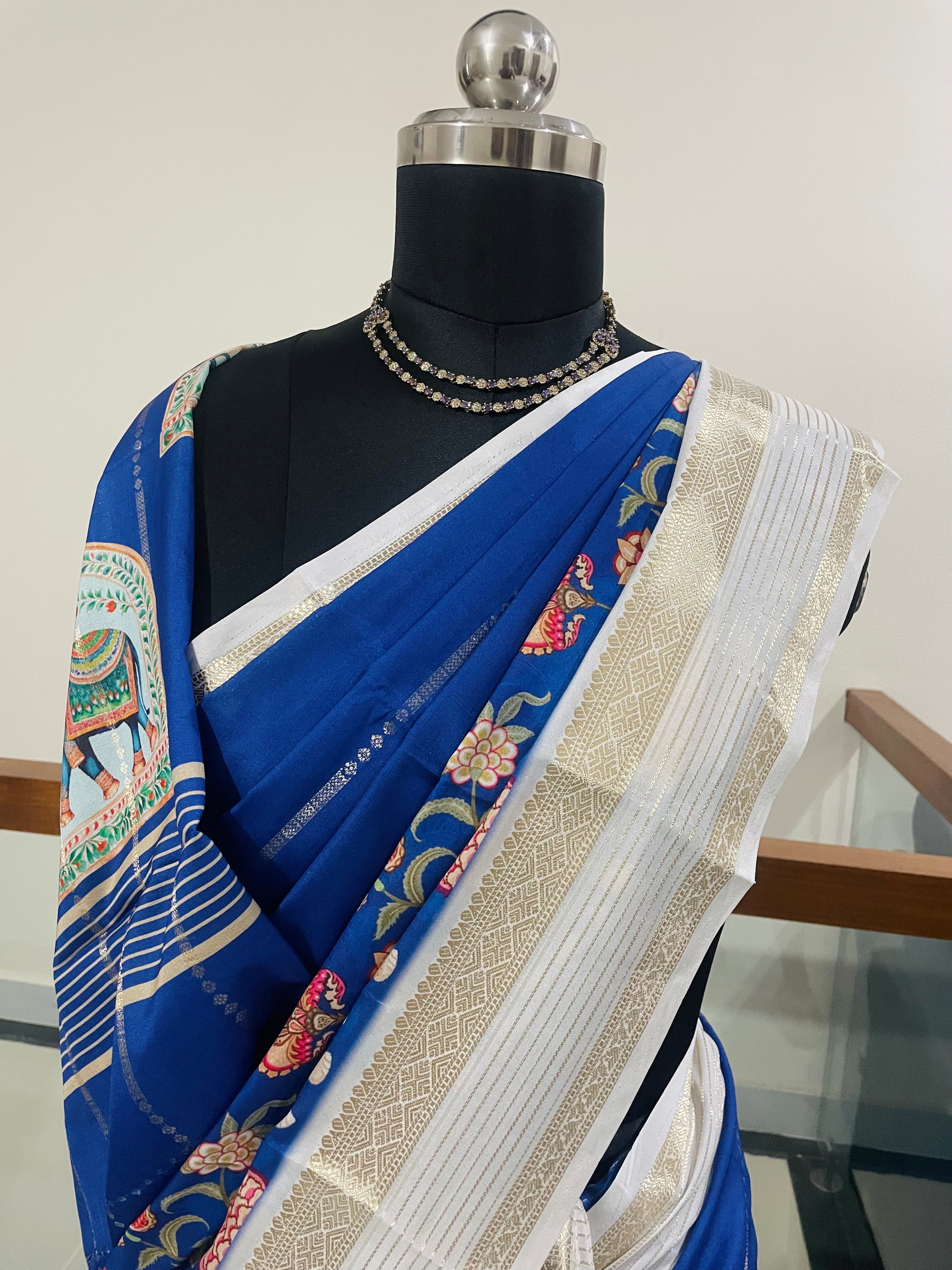 Elegant Royal Blue Yulu Crape semi silk Saree with Elephant artistry Prints with Gold Zari White Border.