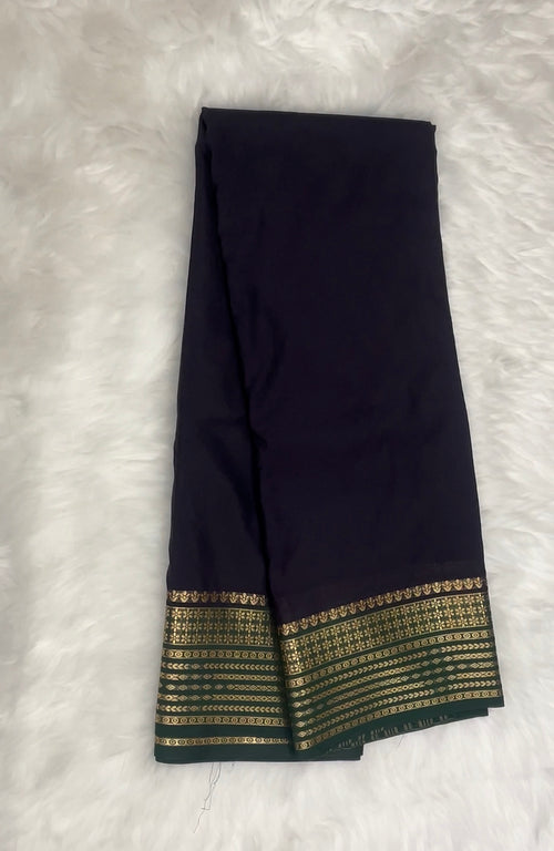 Beautiful Crepe Semi Silk Saree with Striking Combination Of Navy Blue with Green and gold border, giving it a Regal and Elegant look.