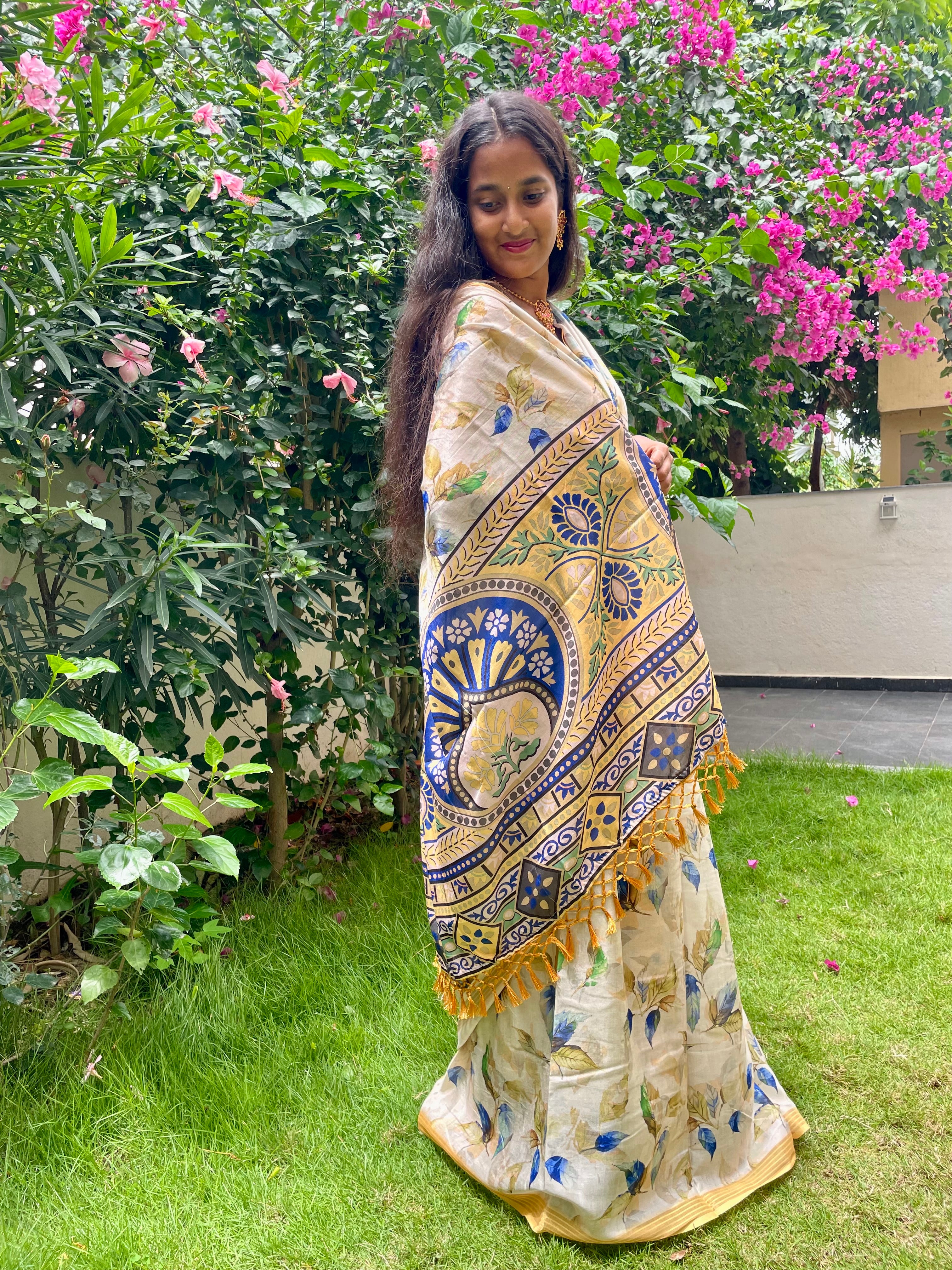 Elegant Beige Floral Cotton silk Soft Saree with Royal Blue Accents and Complemented by Golden Border With Tassel Detailing.