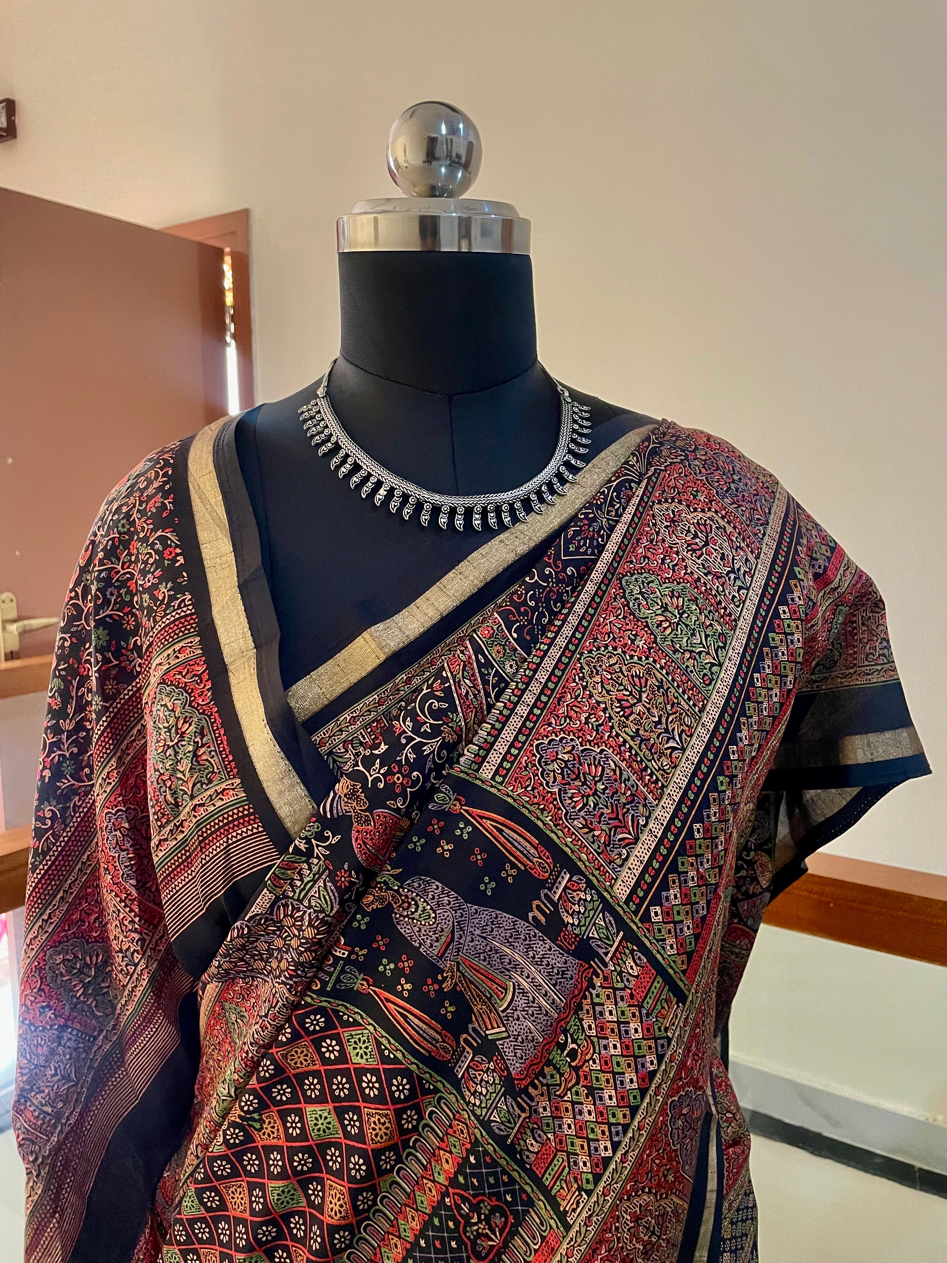 Elegant Heritage inspired Printed Saree showcases traditional Motifs in Rich shade of Maroon, Black and Gold Zari Border.