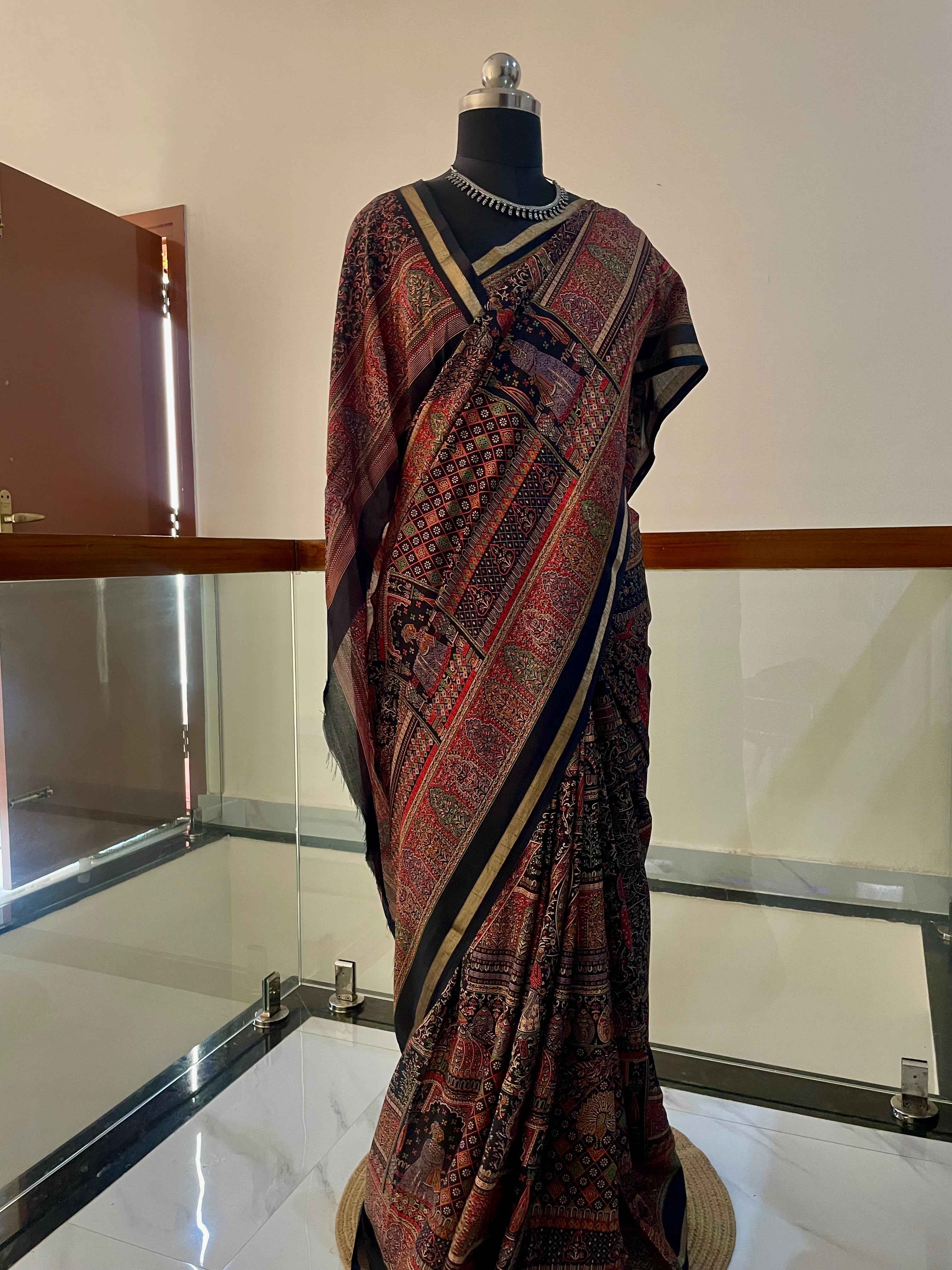 Elegant Heritage inspired Printed Saree showcases traditional Motifs in Rich shade of Maroon, Black and Gold Zari Border.