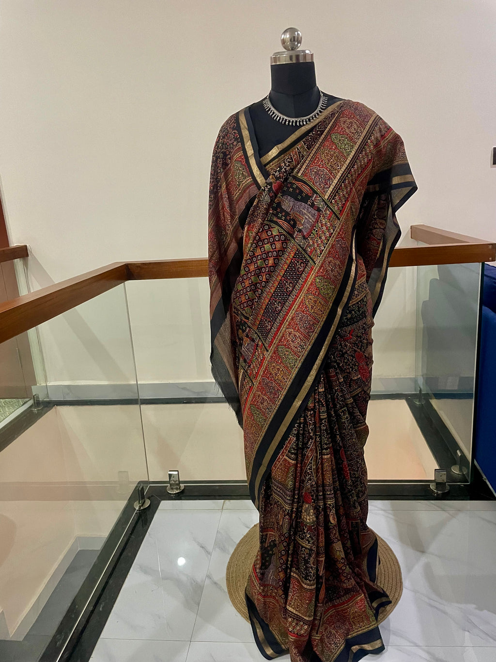 Elegant Heritage inspired Printed Saree showcases traditional Motifs in Rich shade of Maroon, Black and Gold Zari Border.