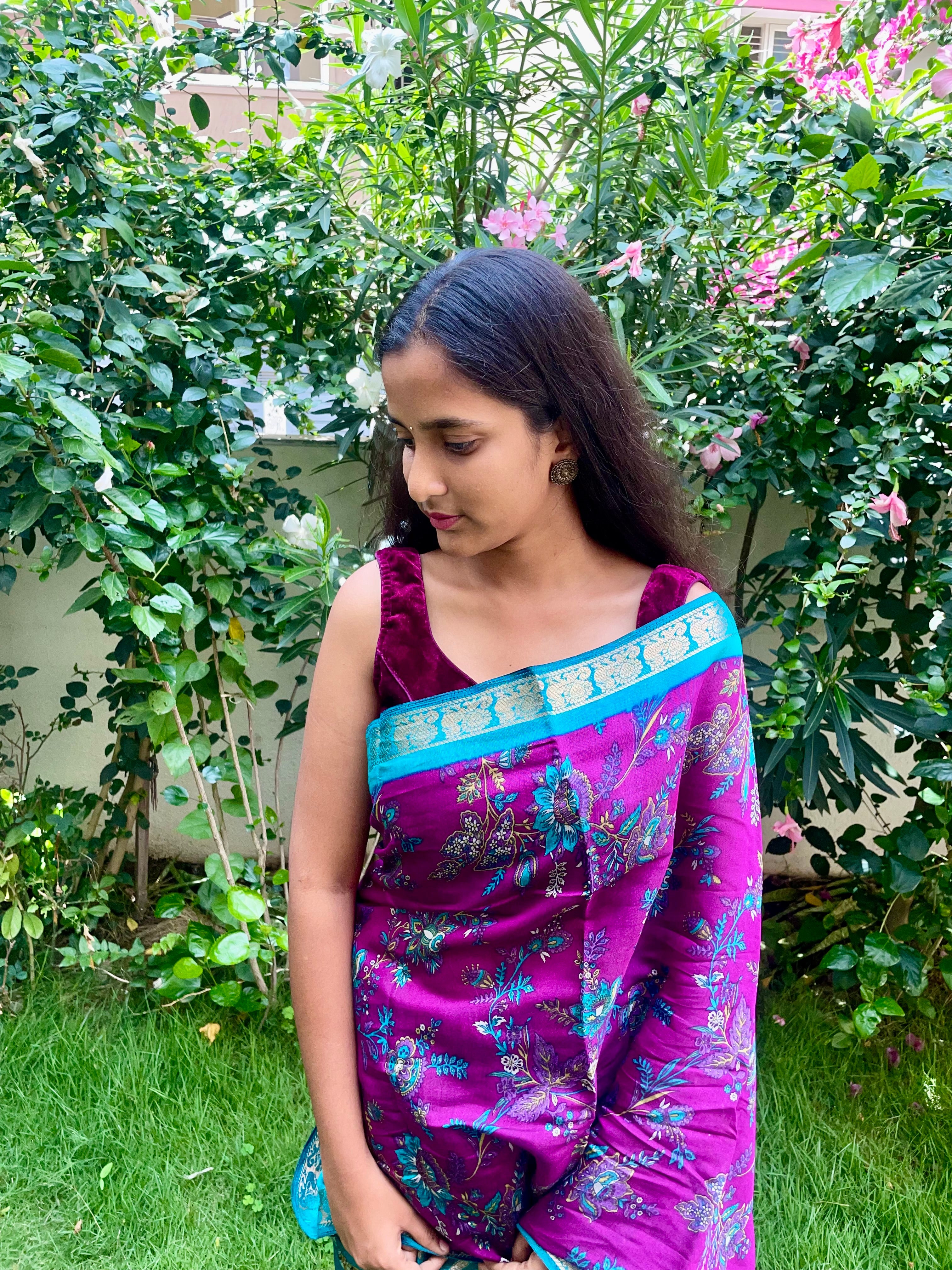 Elegant Rich Magenta Purple Satin Silk Mix Saree with Floral Motifs, Beautifully complemented by a Vibrant Turquoise Blue Border with Traditional Zari.