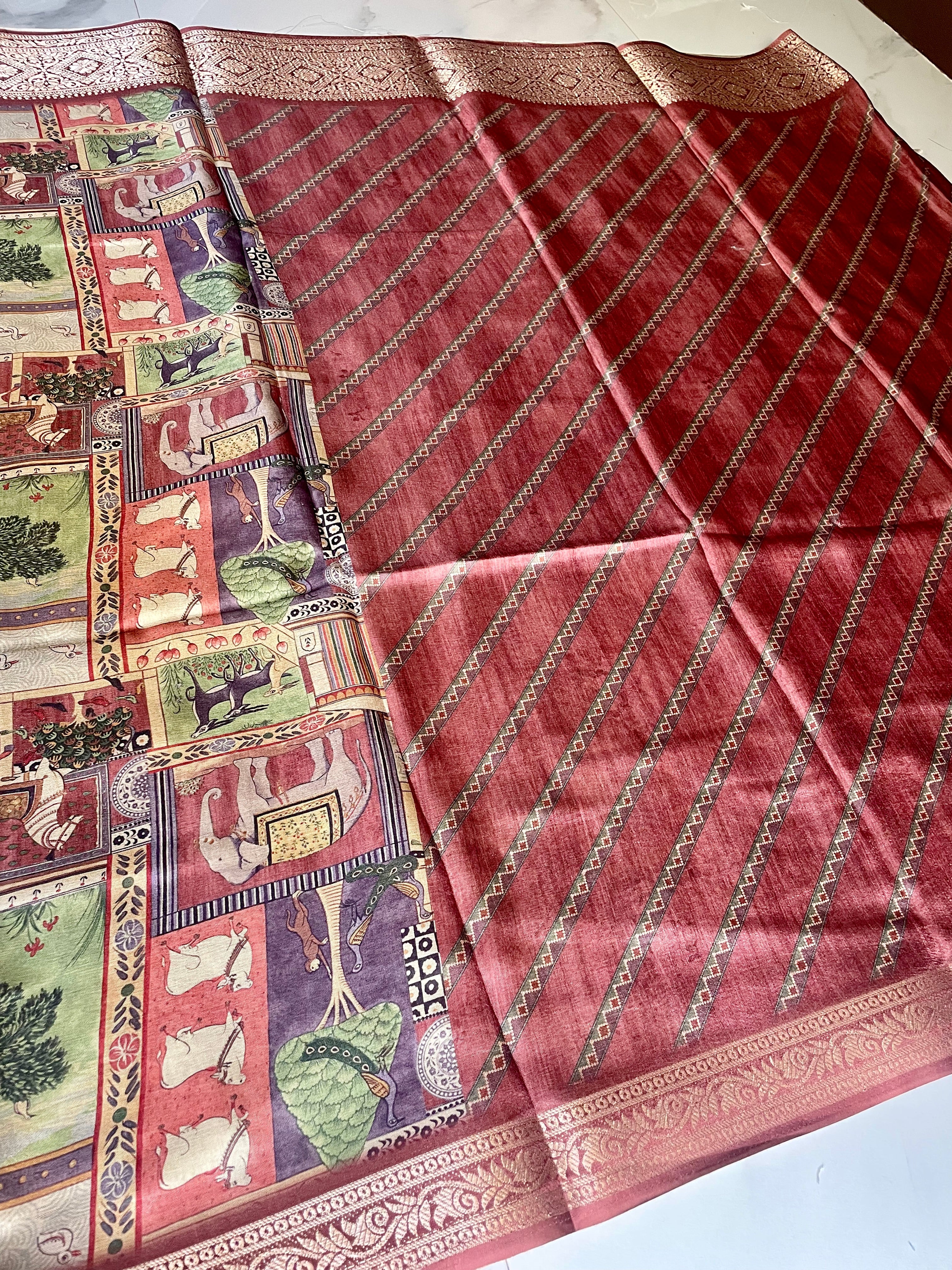 Elegant  maroon heritage-print saree featuring intricate patchwork-inspired motifs with rich woven zari border - Satin Tissue Saree