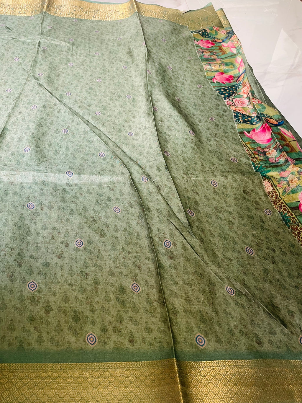 Elegant sage green saree featuring a graceful peacock and nature-inspired print  with rich woven zari border - Satin Tissue Saree