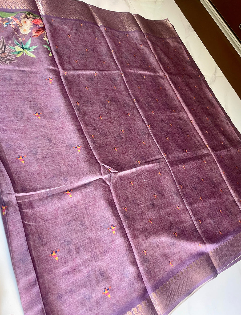 Elegant  lavender-purple saree featuring beautiful  illustrated bird and floral prints with rich woven zari border - Satin Tissue Saree