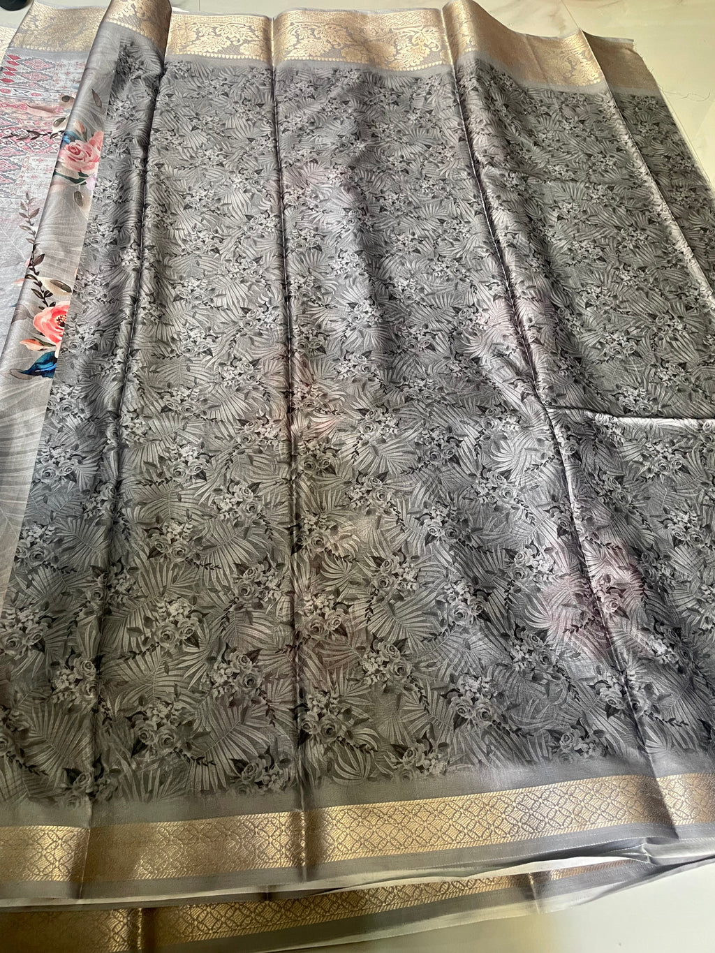 Elegant silver-grey saree featuring beautiful pink floral prints with rich woven zari border - Satin Tissue Saree