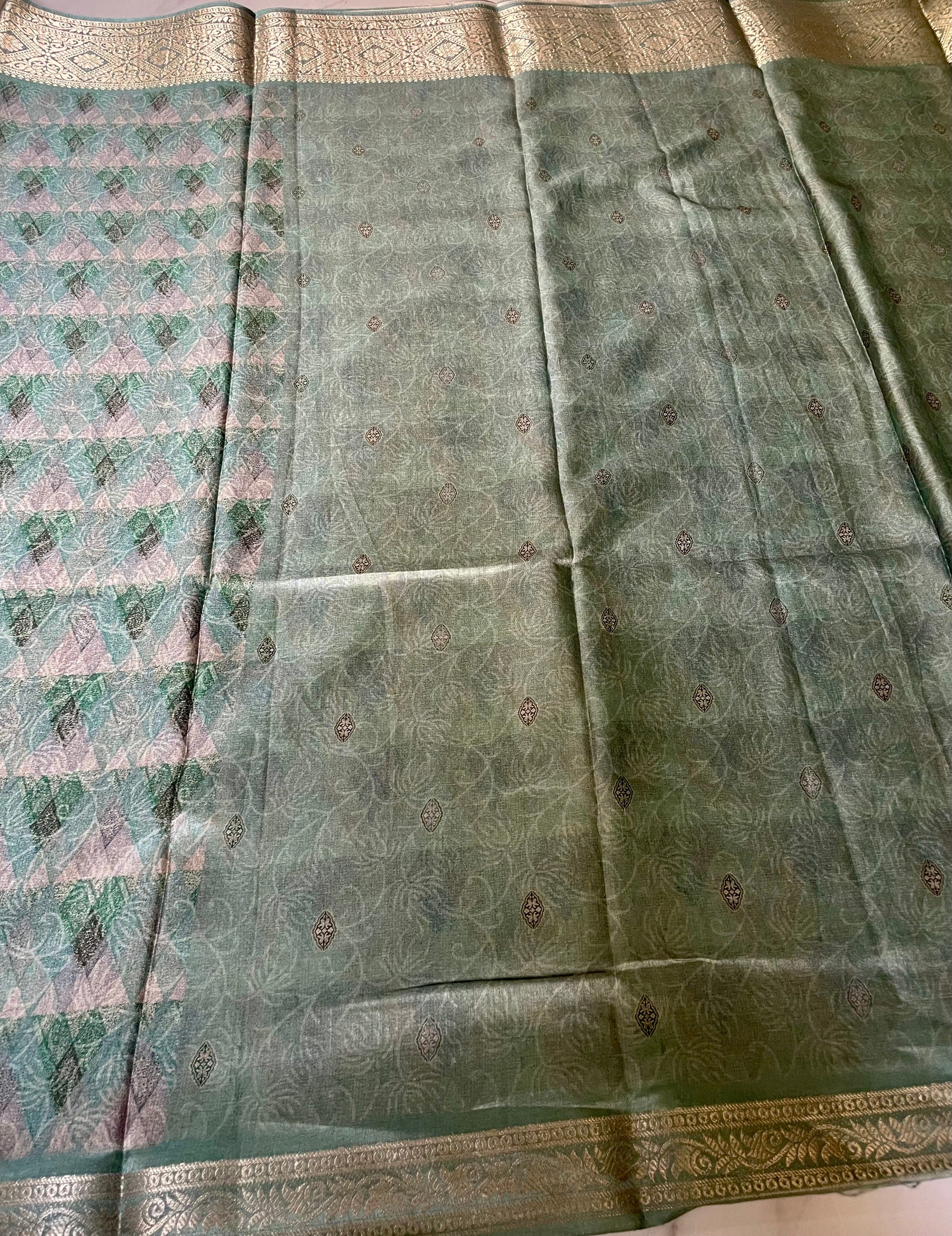 Elegant teal green saree featuring an all-over geometric pattern with rich zari border - Satin Tissue Saree