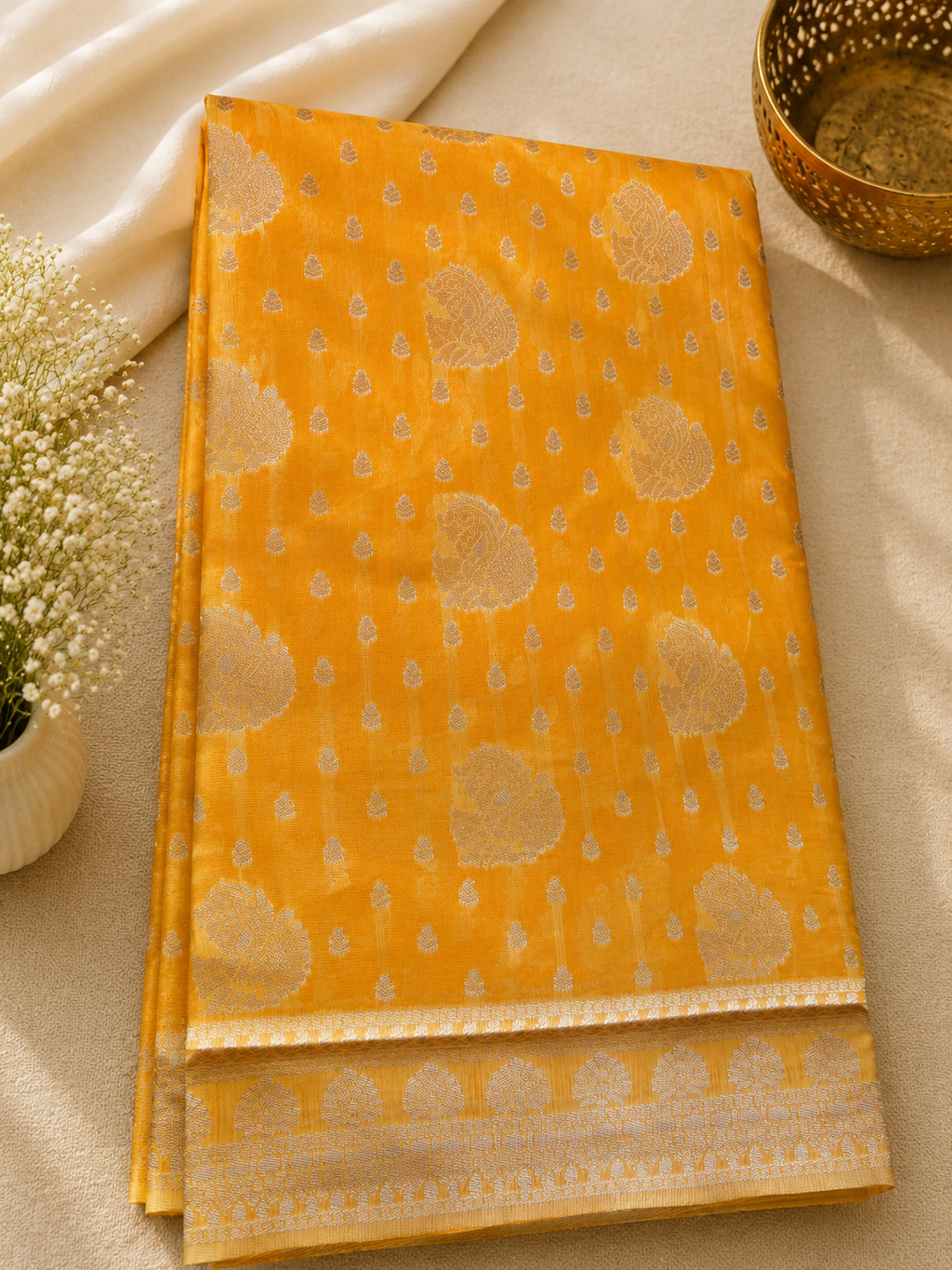 Elegant mustard yellow Cotton saree featuring intricate silver paisley motifs and delicate detailing with silver border