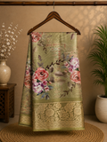 Elegant sage green saree featuring a graceful floral print in soft pink and lavender hues with rich woven zari border - Satin Tissue Saree (Copy)