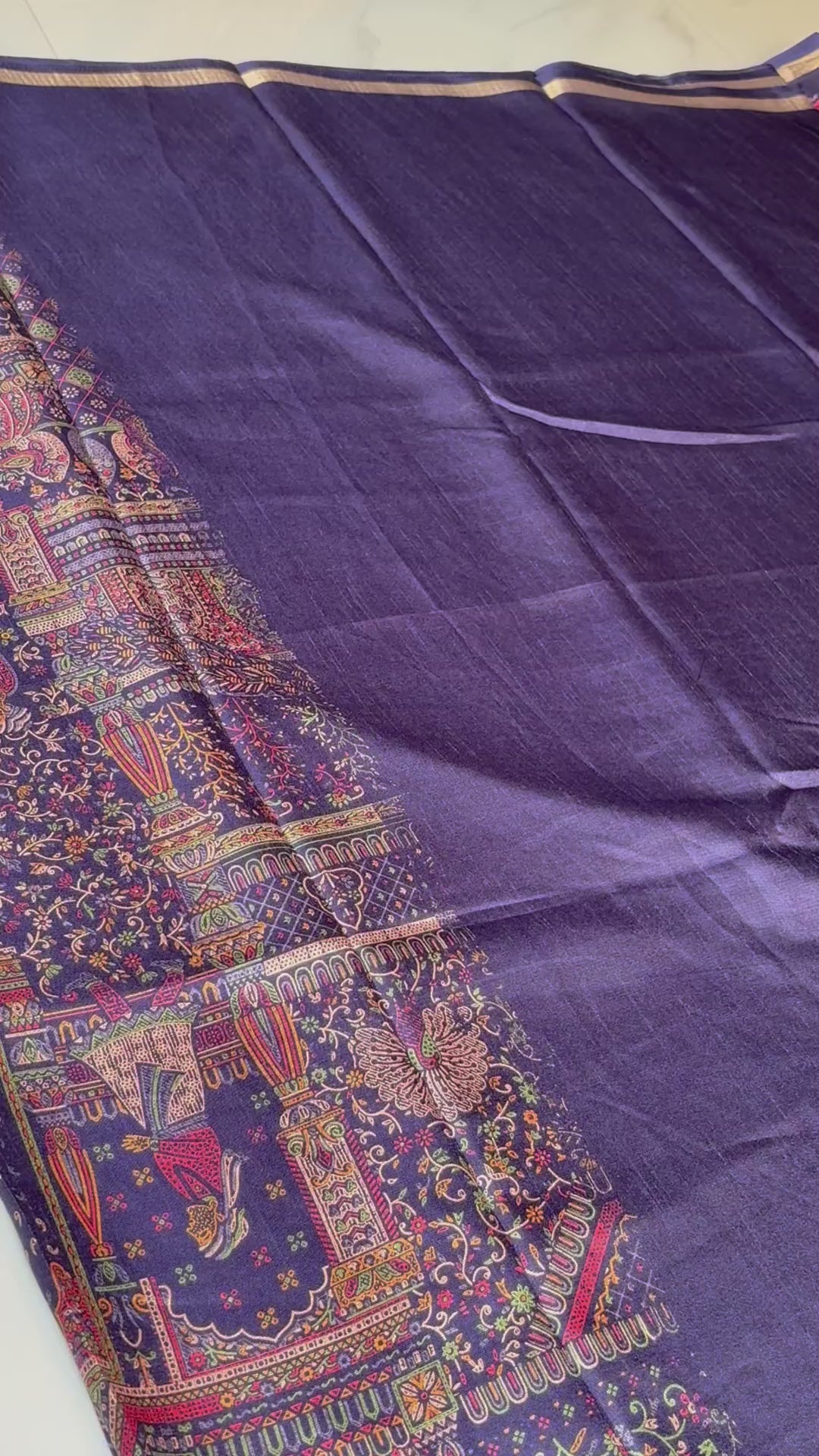 Elegant Navy blue saree, adorned with intricate multicolor ethnic prints and artistic motifs and  subtle golden edging.